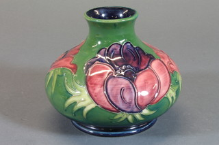 A Moorcroft circular green glazed squat shaped vase decorated anemone, base with signature mark 4"  ILLUSTRATED