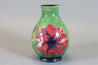 A Moorcroft green glazed club shaped vase decorated anemone  7"  ILLUSTRATED