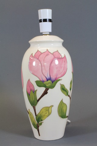A Moorcroft ivory glazed table lamp of club form decorated  pink magnolia