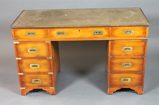 A yew wood military style pedestal desk, the top inset with green leather gilt tooled skiver, fitted an arrangement of 9 drawers,  raised on shaped bracket feet 29"h x 48"w x 21.5"d