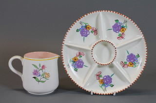 A circular Poole Pottery jug decorated flowers, base impressed  Poole England 320 4" and a circular Poole Pottery dish, base  impressed 362 8.5"