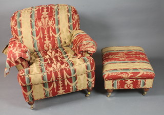 A modern open arm chair together with a matching ottoman  upholstered in a Regence style fabric