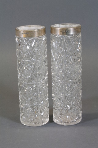 A pair of cylindrical cut glass vases with silver collars 7.5"