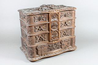 A 19th Century carved oak jewellery box in the Bavarian style  having a hinged lid and 6 swing out containers, raised on plinth  base bun feet 12.5"h x 14"w x 8.5"d