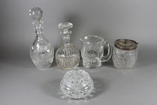 2 cut glass mallet shaped decanters and stopper, cut glass water jug, do. powder bowl and a biscuit barrel with plated mounts