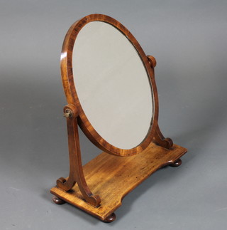 A William IV mahogany toilet mirror, the oval plate with scroll supports raised on bun feet 23"h x 17.5"w x 9"d