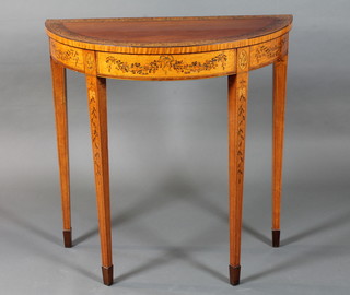 An Edwardian Sheraton revival satinwood demi-lune Pier table, crossbanded and decorated with ribbons and tendril of bell  flowers, raised on square tapered legs, spade feet 36"h x 35.5"w  x 17.5"d  ILLUSTRATED