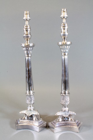 A pair of silver plated Empire style table lamps raised on triform bases 24"