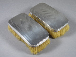 A pair of silver backed military hair brushes Birmingham 1913