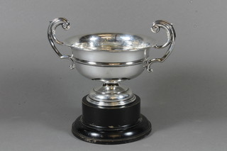 A silver twin handled trophy cup, raised on a spreading foot Birmingham 1929, 8 ozs