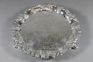 A Victorian engraved silver salver, the rim cast grapes, raised on 3 pierced panel supports, Sheffield 1839, 21 ozs, foot repaired   ILLUSTRATED