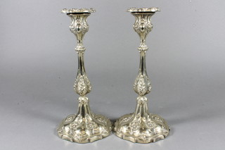 A pair of embossed silver plated candlesticks with detachable  sconces 10"