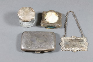 A silver cigarette case, a silver easel photograph frame, a circular  cut glass jar with silver lid and a plated decanter label