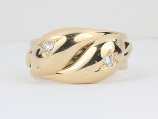 An 18ct yellow gold dress ring in the form of 2 entwined  serpents, the eyes set diamonds
