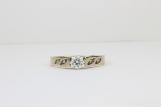 A lady's 9ct gold dress ring set a solitaire diamond