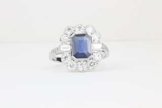 A lady's 18ct white gold dress ring set a rectangular cut sapphire surrounded by diamonds, approx 1.35/1.15ct