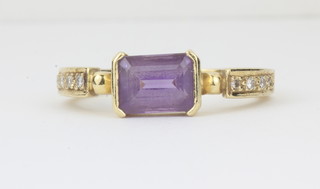 A lady's 18ct gold dress ring set a rectangular amethyst and with diamond to the shoulders