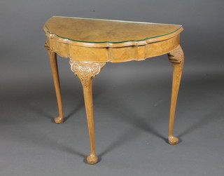 A Queen Anne style walnut demi-lune side table, having shaped top, raised on foliate and acanthus leaf carved cabriole legs, pad  feet 29.5"h x 36"w x 18"d