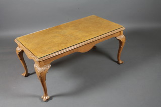 An early 20th Century burr walnut coffee table in the mid 18th  Century taste, raised on foliate carved cabriole legs, scroll feet  19.5"h x 42"w x 22.5"d