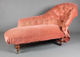 A mid Victorian mahogany framed chaise longue, having pink  buttoned velvet upholstery, raised on turned legs and casters -  a.f., 65"l