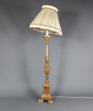 A 17th Century Italianate style carved pine standard lamp, raised  on trefoil base, claw feet 50.5"h