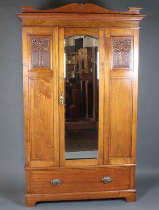 An Art Nouveau walnut wardrobe, having moulded cornice  above a central glazed door, flanked by relief carved panels depicting apple trees, with drawer below, raised on shaped plinth  base, lock plates stamped MAC, 87"h x 54"w x 21"d