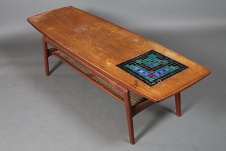 A 1960's Danish teak coffee table, the shaped rectangular top  inset mosaic tiles with second tier below, raised on shaped legs,  bears Danish Craftsmanship label to underside 17"h x 58"w x  19"d