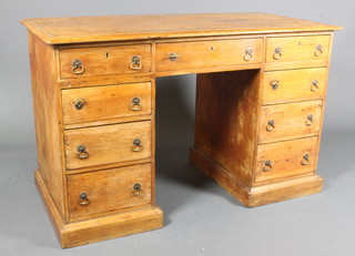 A Victorian pine pedestal desk having a rectangular moulded top above an arrangement of 9 drawers, raised on plinth bases,  30.5"h x 48"w x 24"d