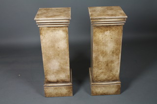 A pair of neo classical style pedestals, having square moulded  tops raised on plinth bases, 34"h x 12.5"w x 12."d