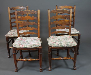 A set of 4 18th Century oak and elm ladder back chairs, fitted  rush seats, raised on turned legs united by stretchers