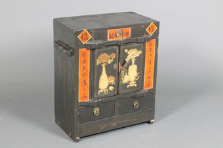 An early 20th Century Japanese lacquered Kodansu, decorated  with urns of flowers and panels of script and fitted 3 small  drawers with 2 small cupboard doors, on end supports 20"h x  17.5"w x 10"d