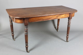 A Regency mahogany D end extending dining table, end sections  only, having a reeded moulded top, raised on ring turned tapered  legs, brass caps and casters 28"h x 55"w x 52"l