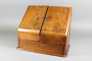 A late Victorian walnut correspondence box, having a split  hinged fall enclosing a compartmentalised interior, raised on  plinth base 11.5"h x 13"w x 8"d