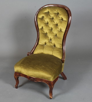 A Victorian style stained beechwood spoon back low seat chair, having buttoned green velvet upholstery raised on cabriole legs