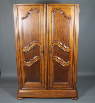 An early 19th Century style stained beechwood "Normandy"  armoire, having a pair of fielded cupboard doors enclosing a  linen shelf with 8 small drawers below, raised on plinth base and  flattened bun feet 73"h x 46"w x 23"d