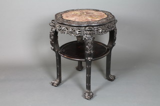 A late 19th Century Chinese carved Padouk wood 2 tier  jardiniere stand, the shaped circular top inset rouge marble panel  within foliate relief carved reserves above a pierced foliate carved  frieze with second tier below, raised on shaped square legs, claw  and ball feet 31"h x 28"d ILLUSTRATED