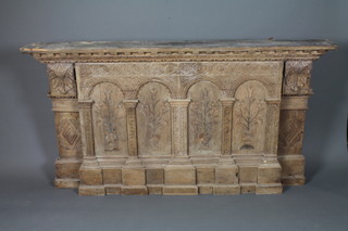 A 19th Century Flemish carved oak architectural facade with a  foliate and dentil cornice above a guilloche carved colonnade,  inset marquetry panels of floral urns, raised on a stepped plinth  base, 40"h x 74"w x 8.5"d
