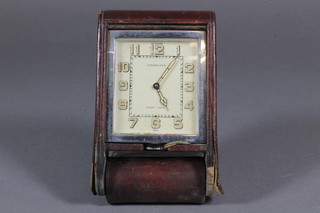 LeCoutre, a 1930's travelling desk timepiece having Morocco leather folding case, the timepiece with Arabic Tritium dial,  retailed by Finnegans, set 8 day movement 4"l x 2.5"w