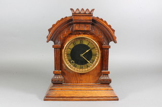 A late 19th Century American oak mantel clock of architectural form having gilded Roman dial, set 8 day two train movement,  chiming gong, 14"h x 11.5"w x 15.5"d
