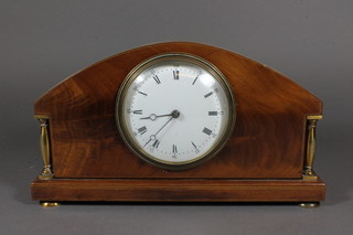 An Edwardian mahogany mantel timepiece, having Roman and  Arabic enamelled dial, flanked by polished brass column supports  and set cylinder movement with lever escapement, raised on  flattened bun feet 6"h x 10"w x 3.5"d