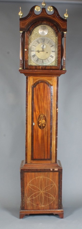 A late George III mahogany longcase clock, the case with broken swan neck pediment above a broken arch topped door, flanked by  turned column supports, the trunk door centred with a patterae  depicting musical motifs above a box base, raised on bracket feet.  The 12" broken arch brass dial with foliate spandrels and Roman  and Arabic silvered chapter ring and second subsidiary dial, set 8  day movement with anchor escapement striking bell, the dial  monogrammed SRM, 92"h x 19"w x 11"d