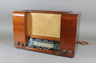 An Invicta radio contained in a walnut case