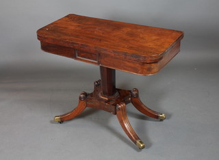 A George IV mahogany D shaped card table, the hinged top  enclosing a baise lined interior, raised on an octagonal column  supports with quadripartite base, brass caps and casters 29.5"h x  36"w x 36"d
