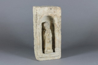 A carved stone figure of St Peter complete with niche 5"
