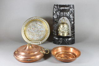 A Japanese bronze table bell decorated a dragon, raised on a  hardwood stand 7", a circular brass tray 11", a copper dish and a  copper and brass foot warmer 8.5"