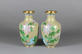 A pair of Japanese green ground cloisonne enamelled vases decorated birds amidst branches 6"