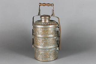 A cylindrical Oriental embossed metal 3 section food carrier