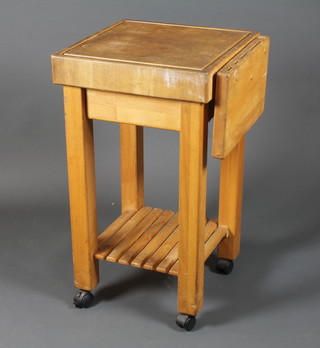 A modern maple butcher's block, raised on square legs and  casters 34.5"h x 21.5"w x 19.5"d