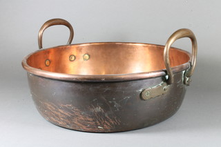 A circular twin handled copper preserving pan marked SC1