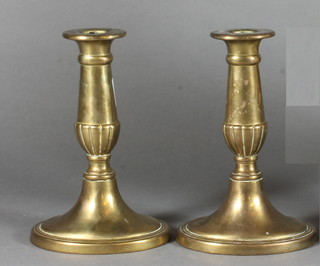 A pair of brass stub shaped candlesticks 6" and a plaster portrait bust of Apollo 12"